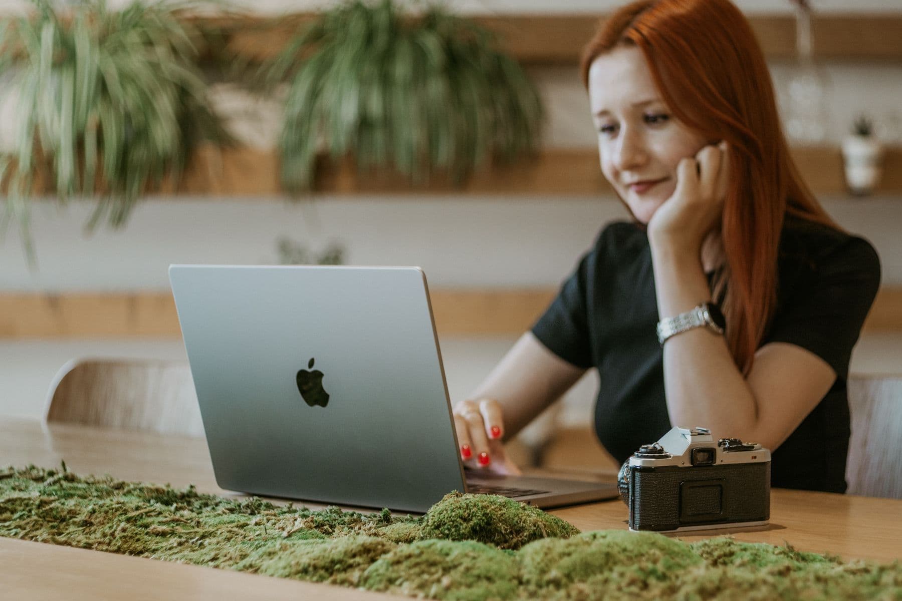 Une propriétaire crée son compte sur son ordinateur portable, entourée de plantes